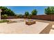 Landscaped backyard featuring a fire pit, desert landscaping and a brick wall surround at 4724 S Anitole Way, Mesa, AZ 85212