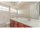 Bathroom featuring double sink vanity, large mirror, and natural light at 4724 S Anitole Way, Mesa, AZ 85212