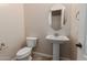 Powder room features pedestal sink and oval mirror at 4724 S Anitole Way, Mesa, AZ 85212