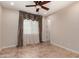 Bedroom with tile flooring, ceiling fan, and natural lighting at 4724 S Anitole Way, Mesa, AZ 85212