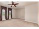 Spacious bedroom with neutral carpet, ceiling fan and windows with decorative valances at 4724 S Anitole Way, Mesa, AZ 85212