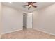 Tiled flooring, ceiling fan, and neutral walls enhance this comfortable bedroom space at 4724 S Anitole Way, Mesa, AZ 85212