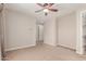 Neutral bedroom featuring ceiling fan and an ensuite bathroom with walk in closet at 4724 S Anitole Way, Mesa, AZ 85212