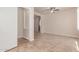 Tile flooring, ceiling fan, and walk-in closet featured in this spacious, well-lit bedroom at 4724 S Anitole Way, Mesa, AZ 85212