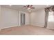 Neutral carpeted bedroom features ceiling fan, recessed lighting, and en-suite bathroom at 4724 S Anitole Way, Mesa, AZ 85212