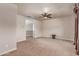 A large carpeted bedroom with ceiling fan leads to an open area and upstairs railing at 4724 S Anitole Way, Mesa, AZ 85212