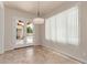 Light-filled dining area features backyard access, sleek pendant lighting, and tile flooring at 4724 S Anitole Way, Mesa, AZ 85212