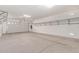 Large, clean garage with ample storage racks, overhead lighting, and automatic door at 4724 S Anitole Way, Mesa, AZ 85212