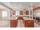 A modern kitchen features two granite islands, stainless steel appliances, and a seamless layout at 4724 S Anitole Way, Mesa, AZ 85212