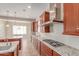 The gourmet kitchen features modern appliances, granite countertops, gas range, and seamless access to the rest of the house at 4724 S Anitole Way, Mesa, AZ 85212
