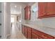 A view of the kitchen with granite countertops, wood cabinets, white subway tile backsplash, and stainless steel appliances at 4724 S Anitole Way, Mesa, AZ 85212