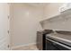 Laundry room features modern washer and dryer with built-in shelving at 4724 S Anitole Way, Mesa, AZ 85212