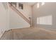Bright living room with high ceilings, large windows, and staircase with wood railing at 4724 S Anitole Way, Mesa, AZ 85212