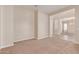 Spacious living room showcasing neutral paint, plush carpeting, and a seamless open layout at 4724 S Anitole Way, Mesa, AZ 85212