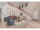 Spacious living room features a soaring ceiling, elegant staircase, and comfortable seating arrangement at 4724 S Anitole Way, Mesa, AZ 85212