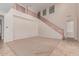 Bright living room boasts a staircase with wood railing and tile flooring at 4724 S Anitole Way, Mesa, AZ 85212
