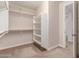 Bright walk-in closet featuring ample shelving and hanging space, providing plenty of room for storage at 4724 S Anitole Way, Mesa, AZ 85212