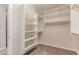 Spacious walk-in closet with built-in shelving and hanging rods for optimal storage and organization at 4724 S Anitole Way, Mesa, AZ 85212