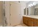 Bright bathroom features a wood vanity, framed mirror, and shower with patterned curtain at 4808 N 24Th St # 923, Phoenix, AZ 85016