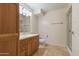 Bathroom vanity with cabinetry, a toilet, and a glass-door shower at 4808 N 24Th St # 923, Phoenix, AZ 85016