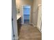 Modern bathroom with a glass enclosed shower, wood-look tile floor, and walk-in closet at 4930 W Brown St, Glendale, AZ 85302