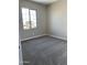 Comfortable bedroom featuring a large window, carpeted floors, and neutral paint at 4930 W Brown St, Glendale, AZ 85302