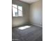 Bright bedroom featuring a large window, plush carpet, and neutral wall colors at 4930 W Brown St, Glendale, AZ 85302