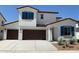 Inviting two-story home featuring a three-car garage, desert landscaping, and a charming architectural design at 4930 W Brown St, Glendale, AZ 85302
