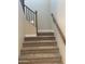 Carpeted staircase with wooden railing offers access to the upper levels of the home at 4930 W Brown St, Glendale, AZ 85302