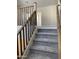 Staircase featuring carpeted steps, a wooden handrail, and access to the upper level of the home at 4930 W Brown St, Glendale, AZ 85302