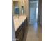 Bathroom featuring dual sinks, granite counters, and neutral tiling and paint at 5004 W Brown St, Glendale, AZ 85302