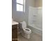 A well-maintained bathroom with a toilet, tub, and sleek tile flooring at 5004 W Brown St, Glendale, AZ 85302