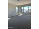 This is a spacious bedroom that is brightly lit with large windows and neutral carpet at 5004 W Brown St, Glendale, AZ 85302