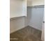 A view of the well-organized closet space, featuring wood rods and carpet flooring at 5004 W Brown St, Glendale, AZ 85302