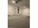 Large garage with white walls, concrete floor, and ample storage space at 5004 W Brown St, Glendale, AZ 85302