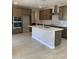 Modern kitchen with a large island, stainless steel appliances, and stone backsplash at 5004 W Brown St, Glendale, AZ 85302