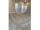 Spacious main bedroom with carpet flooring and access to the ensuite bathroom at 5004 W Brown St, Glendale, AZ 85302