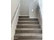 Carpeted staircase with white railing leading to the upper level at 5004 W Brown St, Glendale, AZ 85302