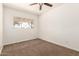 Carpeted bedroom featuring a ceiling fan and a window at 501 W Dublin St, Chandler, AZ 85225