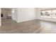 Open-concept living room featuring wood-look floors and a charming brick fireplace and built in bookshelves at 501 W Dublin St, Chandler, AZ 85225
