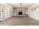 Spacious living room featuring wood-look floors, a brick fireplace, and a bright, airy feel at 501 W Dublin St, Chandler, AZ 85225