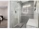 Ensuite bathroom with a glass enclosed shower and tiled walls at 5314 N Las Casitas Pl, Phoenix, AZ 85016