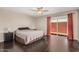 Spacious main bedroom with ceiling fan, dark wood floors, and access to the backyard at 5314 N Las Casitas Pl, Phoenix, AZ 85016