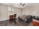 Cozy bedroom featuring dark hardwood floors and a ceiling fan at 5314 N Las Casitas Pl, Phoenix, AZ 85016