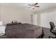 Comfortable bedroom showcasing a ceiling fan, closet doors and warm neutral walls at 5314 N Las Casitas Pl, Phoenix, AZ 85016