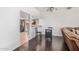 Open dining area with dark wood floors, a modern table, and seamless access to the kitchen at 5314 N Las Casitas Pl, Phoenix, AZ 85016