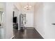 Inviting foyer with dark wood floors, a modern light fixture, and a convenient storage bench at 5314 N Las Casitas Pl, Phoenix, AZ 85016