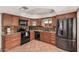 Updated kitchen with granite counters, stylish backsplash, stainless steel refrigerator, and tiled floors at 5314 N Las Casitas Pl, Phoenix, AZ 85016