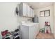Functional laundry room with washer, dryer, cabinets, and storage at 5314 N Las Casitas Pl, Phoenix, AZ 85016