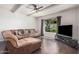 Comfortable living room with a plush sectional, a ceiling fan, and a bright window at 5314 N Las Casitas Pl, Phoenix, AZ 85016